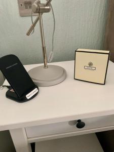 a desk with a laptop computer and a lamp on it at Lochindaal Hotel in Port Charlotte