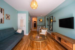 a living room with a couch and a table at BOHEMIAN - SelfCheckIn - Rooftop - Terraces - St-Denis in Montréal