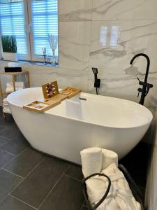 a large white bath tub in a bathroom at JUNIPRO Luxury Apartments in Nohfelden