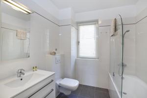 a bathroom with a sink and a toilet and a shower at Casa M Rabac in Rabac +21 photos