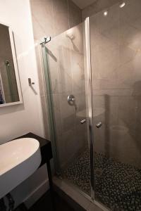 a bathroom with a shower with a sink and a toilet at ZEN - SelfCheckIn - Rooftop - Terraces - St-Denis in Montréal +32 photos