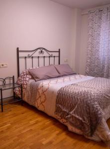 a bedroom with a bed with a metal frame at LA ESTANCIA DE PIZARRO in Gijón