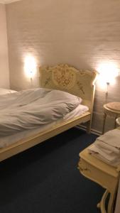 1 dormitorio con 1 cama, 2 lámparas y mesa en Motel Lido en Bredebro