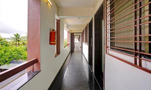 an empty corridor of a building with a window at Itsy Hotels Oasis Pride in Nashik