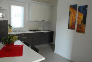 a kitchen with white cabinets and a white counter top at Da Irene in Mestre +8 photos