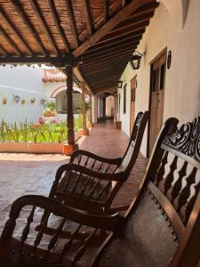 a pair of benches sitting on a porch at Hotel Archangelus in Mompós