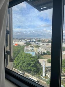 a view of a city from a window of a building at Lindo Flat ao Lado do Aeroporto de Congonhas in São Paulo