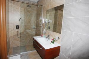 a bathroom with a shower and a sink and a shower at Hotel Green in Tirana +66 photos