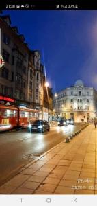 a city street at night with cars and buildings at Apartment Music in Sarajevo
