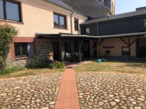 a house with a brick walkway in front of it at Ferien direkt am Wasser in Lychen