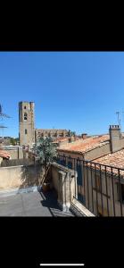 a view of a building with a clock tower at Rooftop Standing Place Carnot in Carcassonne