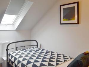 a bedroom with a black and white checkered bed at The Old Chapel in Grosmont