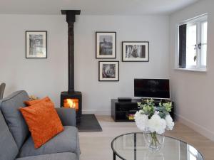 a living room with a couch and a glass table at The Old Chapel in Grosmont