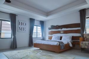 a bedroom with a large bed with a wooden headboard at The Bermondsey apartments in Lagos