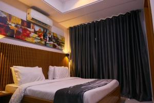 um quarto com uma cama e uma janela com cortinas em The Bermondsey apartments em Lagos