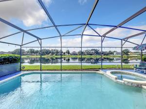 an indoor swimming pool with a view of a river at Glenbrook Pool Lake Home in Orlando