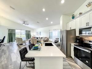 a kitchen and living room with a table and appliances at Glenbrook Pool Lake Home in Orlando