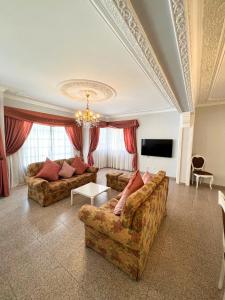 a living room with two couches and a tv at Sunshine Villa in Faro