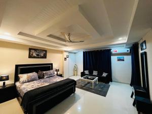 a bedroom with a bed and a living room at Entire 1 BR Apartment: Netflix, Youtube. in Islamabad