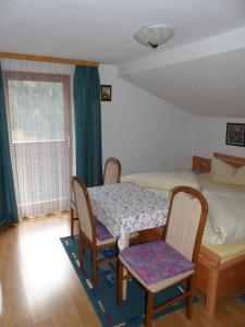 a bedroom with a table and two chairs and a bed at Haus Wechner in Kappl