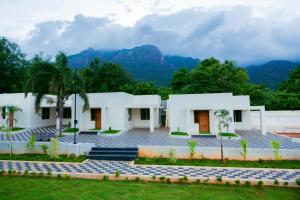 a house with a view of the mountains at WESTN Resorts in Kuttālam
