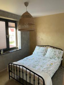 a bedroom with a bed and a lamp and a window at Empero Apartments Bardejov 1 in Bardejov