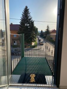 an open door with a gate with a view of a street at Empero Apartments Bardejov 1 in Bardejov