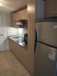 a kitchen with a stainless steel refrigerator and cabinets at Hermoso departamento en la mejor zona de Bariloche in San Carlos de Bariloche