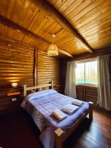 1 dormitorio con 1 cama en una habitación de madera en Mirador de Montaña en Luján de Cuyo
