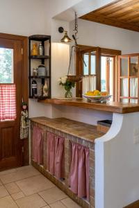 a kitchen with a counter top in a room at Platanos in Vasiliki