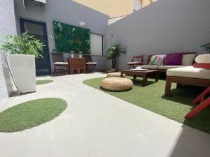 a living room with a couch and tables and grass at Oasis Cotillo in Cotillo