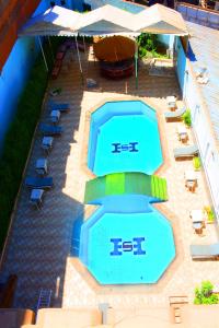 an overhead view of a swimming pool with chairs and umbrellas at Shady Hotel Luxor in Luxor