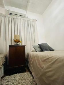 1 dormitorio con cama y ventana en Cabaña La América en Ezeiza