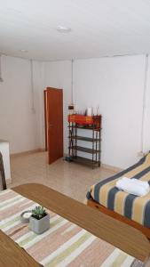 Un dormitorio con una cama y una mesa en una habitación. en Laprida, en Curuzú Cuatiá