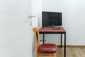 a desk with a computer monitor and a chair at La Dimora del Principe in Bagnoregio
