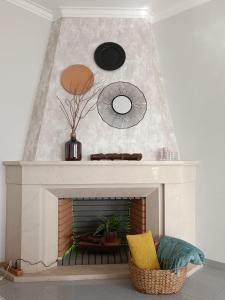 a living room with a white fireplace with a mirror at GREEN GARDEN APARTMENT IN ODIVELAS in Odivelas