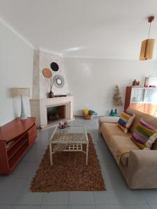 a living room with a couch and a coffee table at GREEN GARDEN APARTMENT IN ODIVELAS in Odivelas