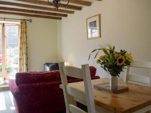 a living room with a wooden table and a couch at Y Bwthyn-uk31367 in Tregynon