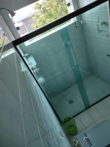 a glass shower in a bathroom with a toilet at Pousada Kavili 150m da Praia in Guarujá +48 photos