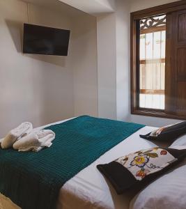 Postel nebo postele na pokoji v ubytování Famy Hostal Nardo's