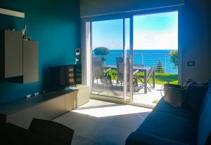 a living room with a view of the ocean at Bellavista in San Lorenzo al Mare