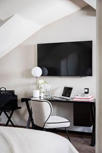 a room with a desk with a tv and a chair at Holiday Inn Paris Palais de l'Elysée by IHG in Paris