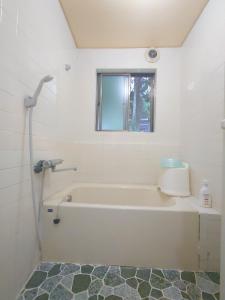 a white bathroom with a tub and a window at Cate no mori - Vacation STAY 20997v in Shime
