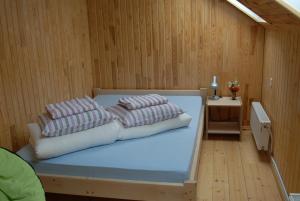 a bedroom with a bed with pillows on it at Atpūtas vieta Upes Sausītes in Sidrabiņi