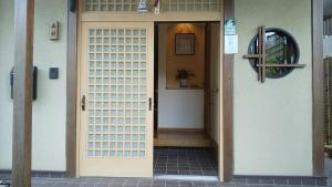 a front door of a house with a doorframe at Guest House Nishimura - Vacation STAY 13436 in Kyoto