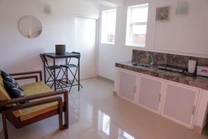 a kitchen with white cabinets and a counter top at The garden gate resort & apartments no 3 in Negombo