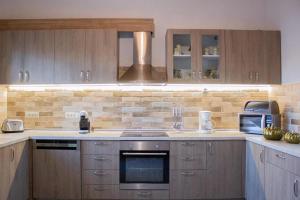 kuchnia z drewnianymi szafkami i piekarnikiem w obiekcie Casa di Famiglia Rhodes w mieście Koskinou