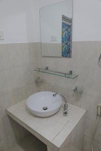 a bathroom with a sink and a mirror at The garden gate resort & apartments no 3 in Negombo