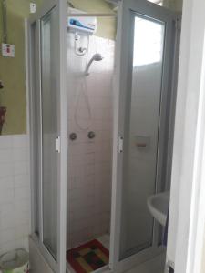 a bathroom with a shower and a sink at Seacastle Deluxe Studio in Montego Bay