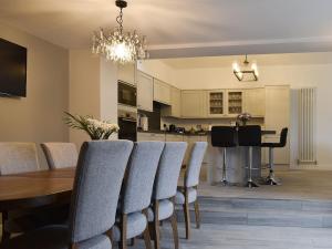 a dining room and kitchen with a table and chairs at The Cottage in Bewdley